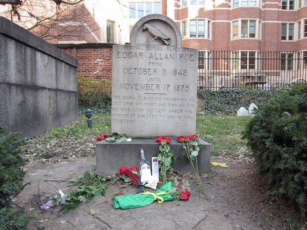 The Poe Toaster left three roses and a bottle of cognac on Poe's original grave.