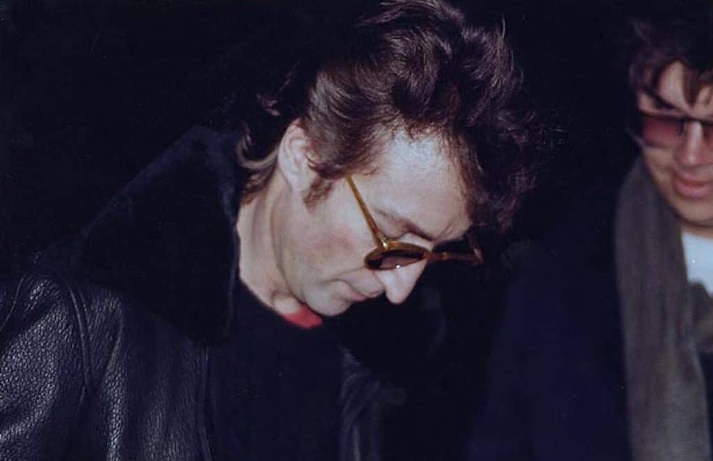 John Lennon (L) shortly before being killed by Mark Chapman (R).