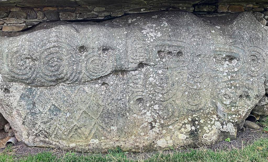 One of the kerbstones of the Newgrange mound displaying ancient designs.