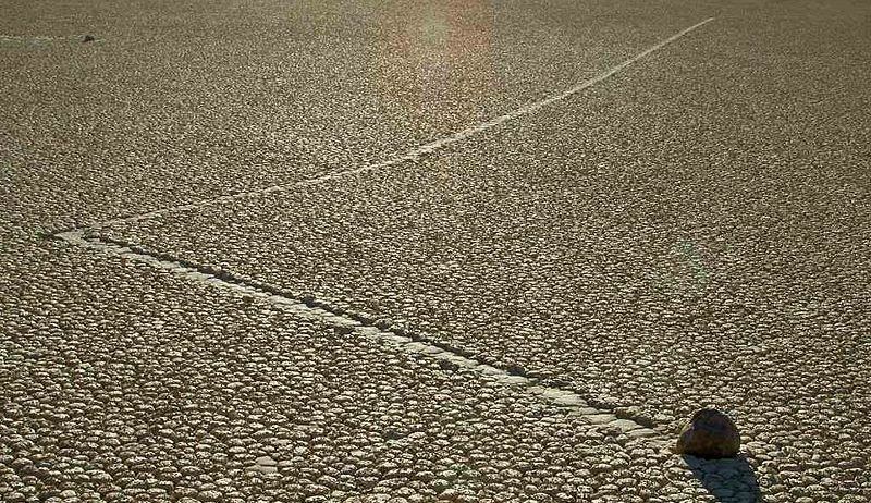 A traveling stone in Death Valley takes an abrupt right turn. Public domain by Jon Sullivan.