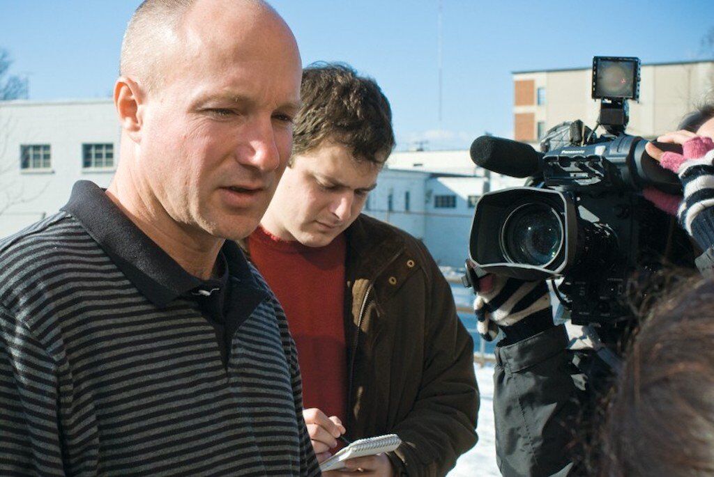 Darrel Rice being interviewed by a journalist.