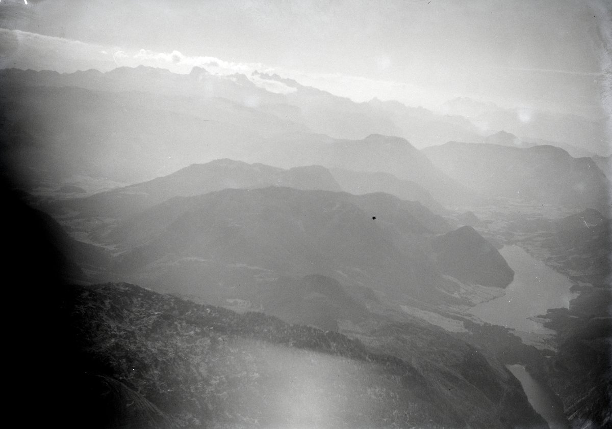 Hazy black and white aerial view of mountains and lakes in the Salzkammergut